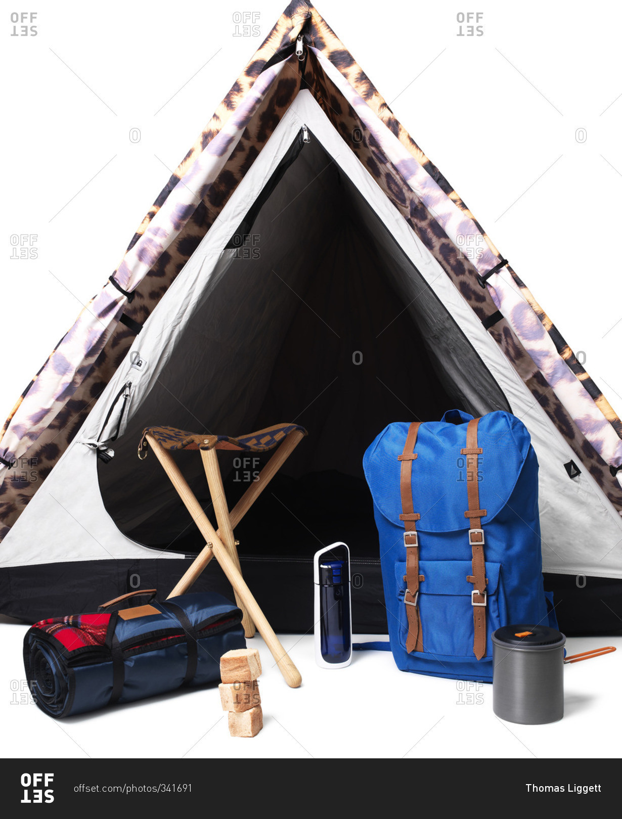Camping gear in front of tent on white