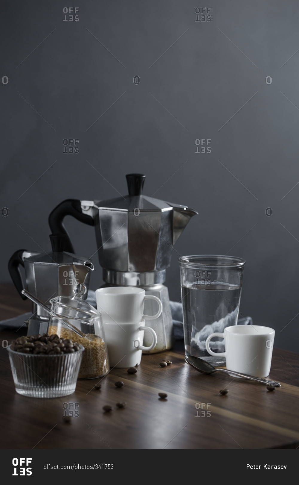 Moka coffee pot and coffee cups on a wood table with raw sugar and ...