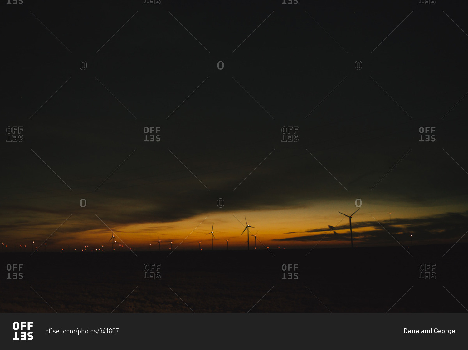 Silhouette of wind turbines at dusk