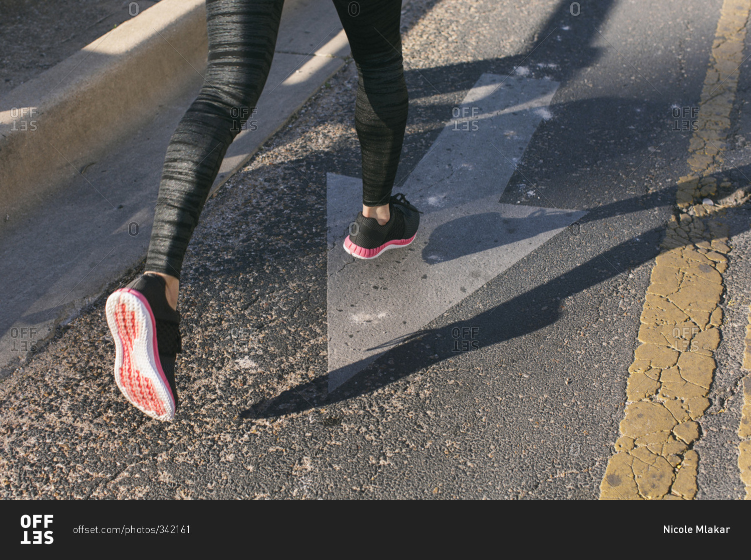 Close-up of woman's shoes as she is running on the street