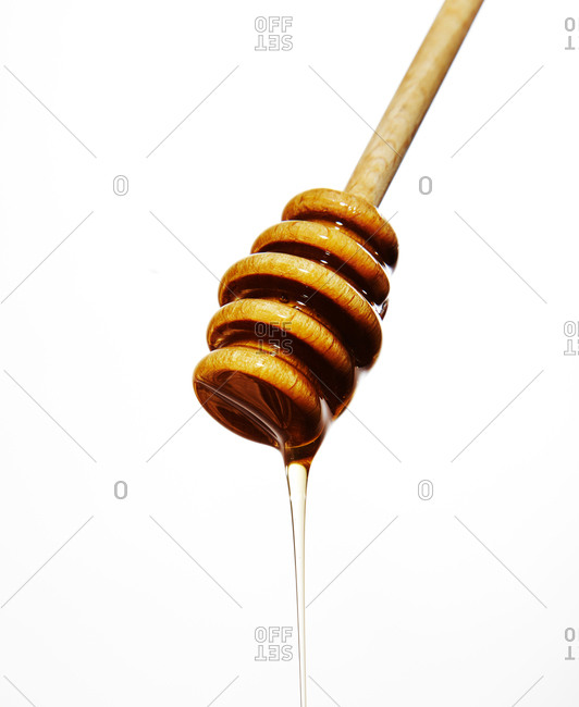 Honey drop at the end of a honey dipper