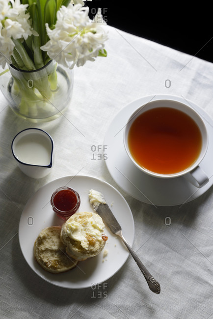 Table set with a cup of tea and scone