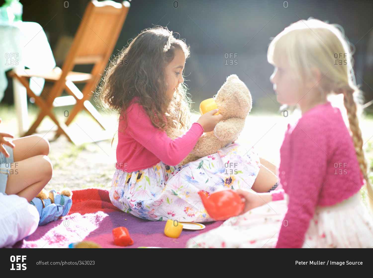 Girls playing picnics at garden birthday party