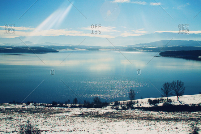 Sunlit view of snow and lake, Montana, Bulgaria