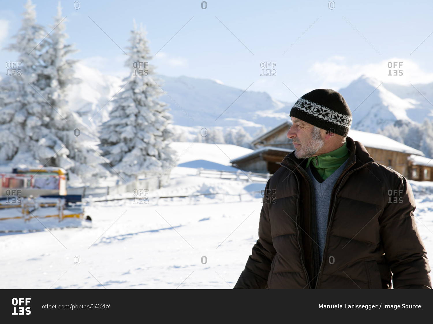 Waist up of senior man and snow covered trees looking away, Sattelbergalm, Tyrol, Austria