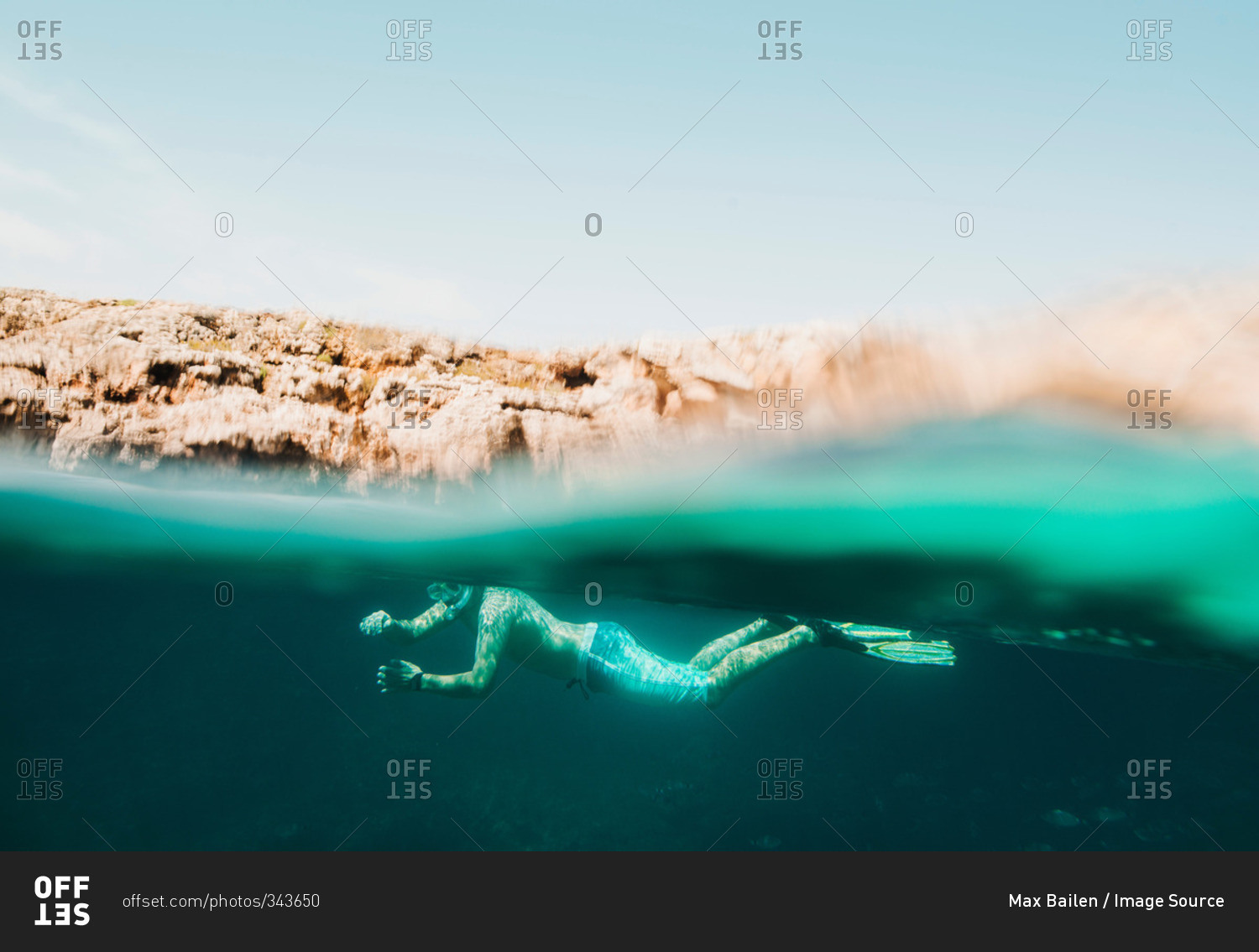 Underwater surface view of mature man sea snorkeling, Menorca, Balearic islands, Spain