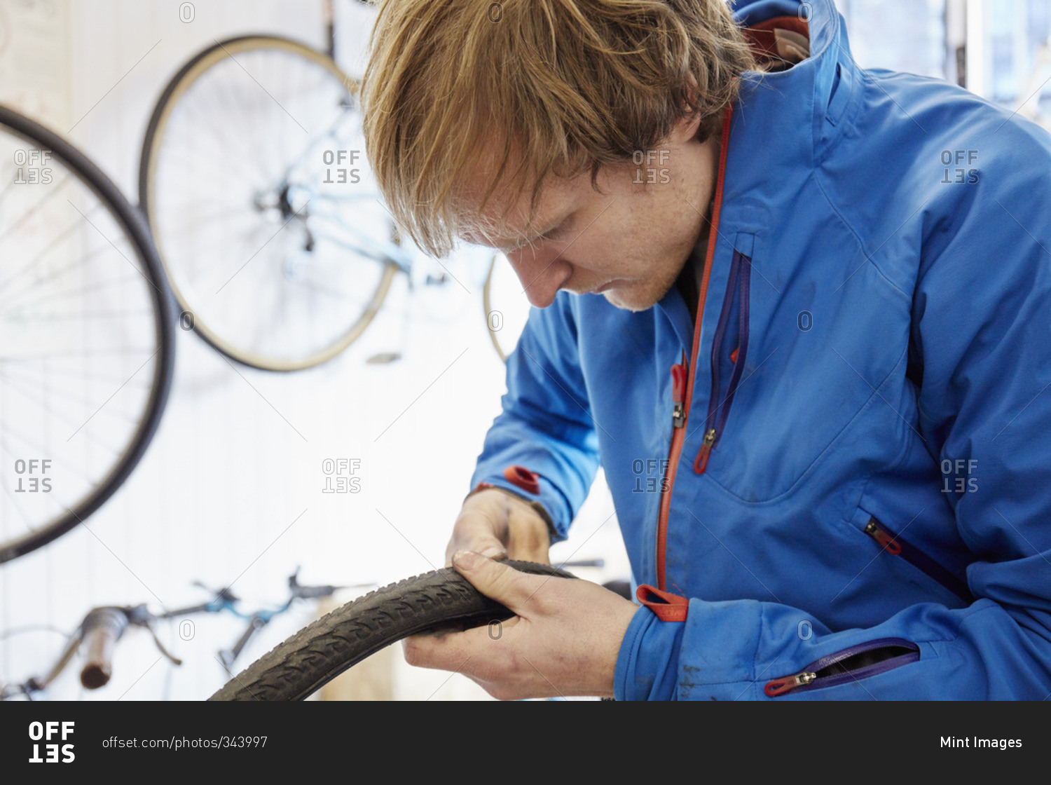 A young man repairing a bicycle