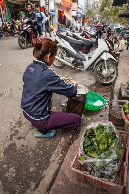 Hanoi, Vietnam - January 19, 2016: Woman preparing a meal of boiled eggs is prepared on the street
