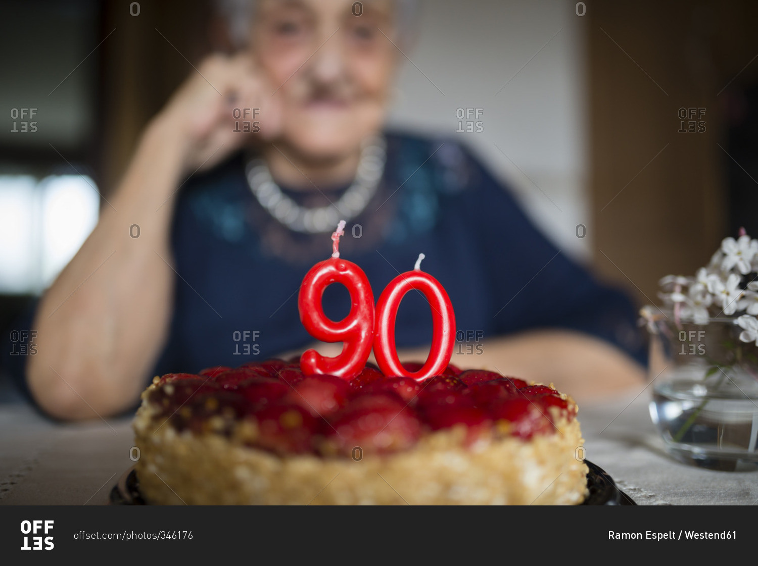 Candles on a birthday cake of a senior woman celebrating her ninetieth birthday
