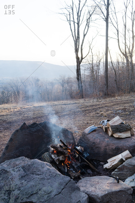 Smoke rising from a campfire in the woods