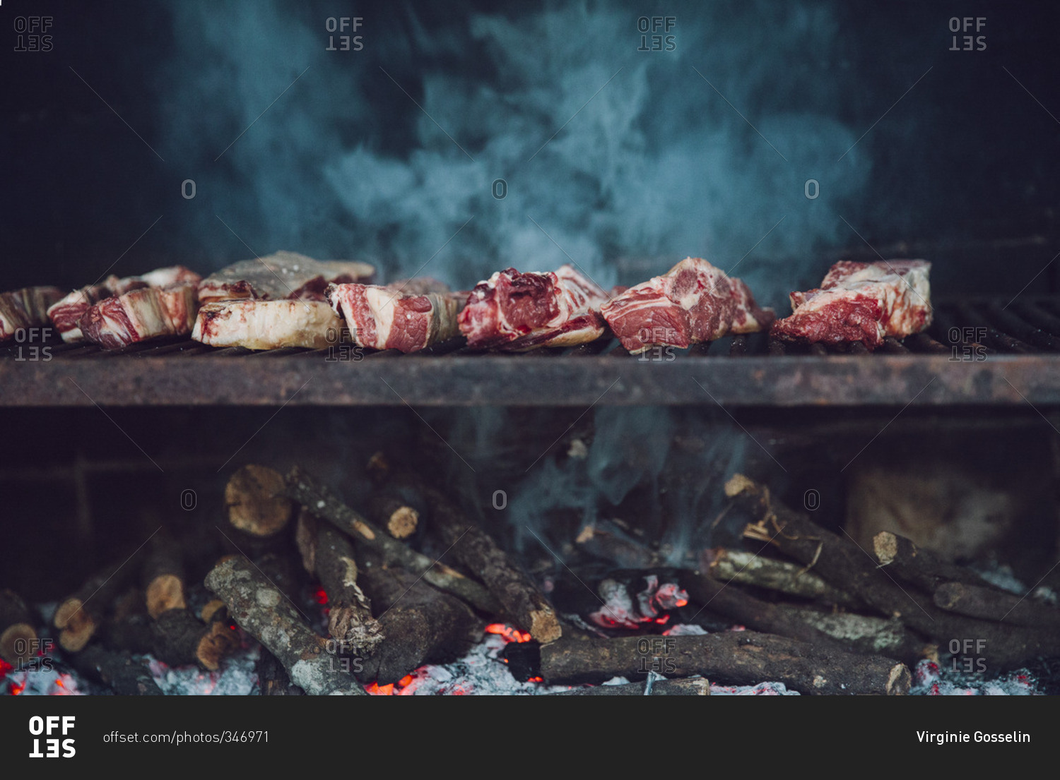 Meat cooking on a wood-fired grill