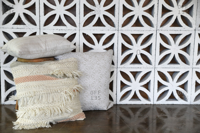 Decorative cement block wall with throw pillows