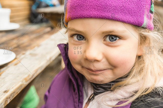 Portrait of young girl in skiwear, smiling, close-up