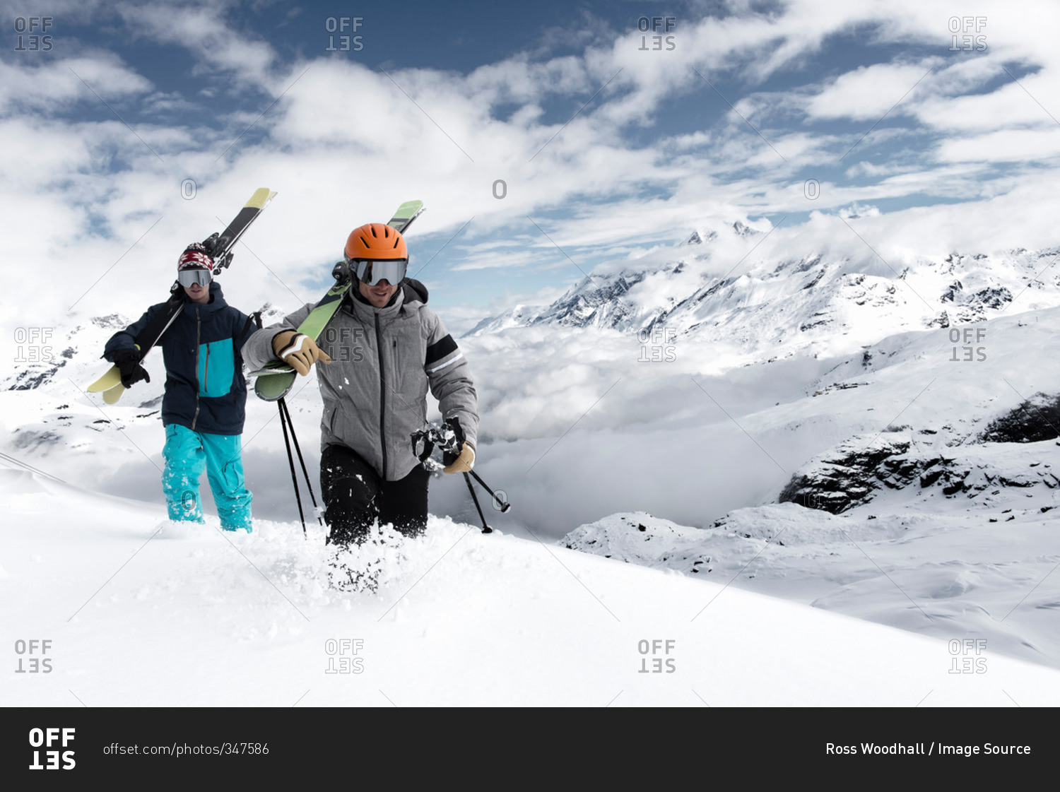Men carrying skis in snow, Zermatt, Valais, Switzerland