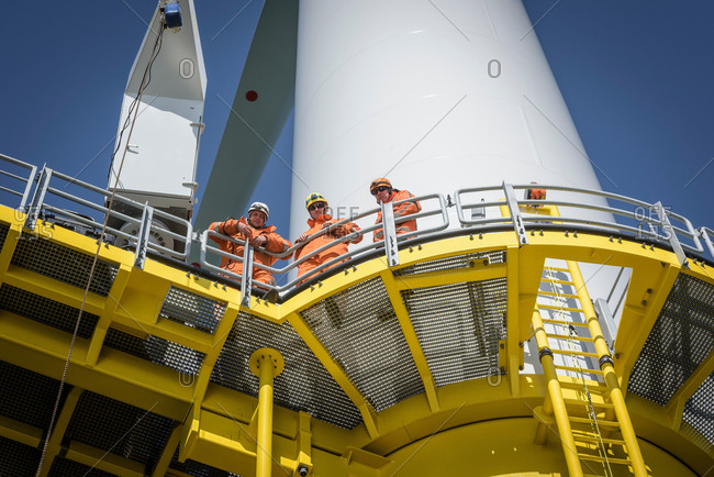 Portrait of engineers on wind turbine on offshore wind farm