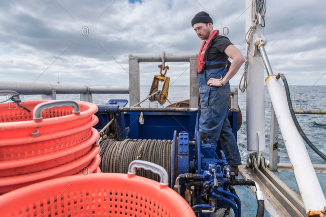 Fisherman with winch on trawler research ship