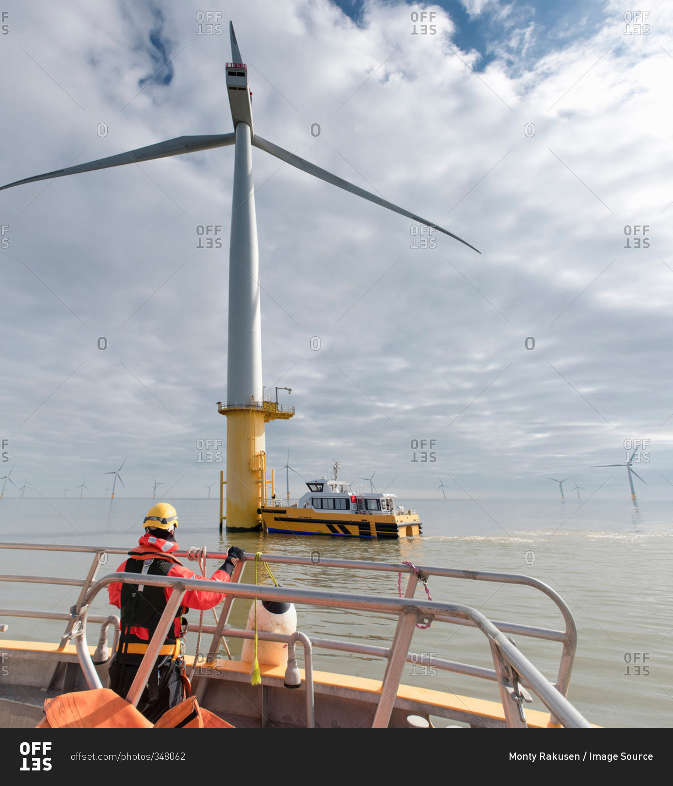 Engineer in boat at offshore windfarm turbine
