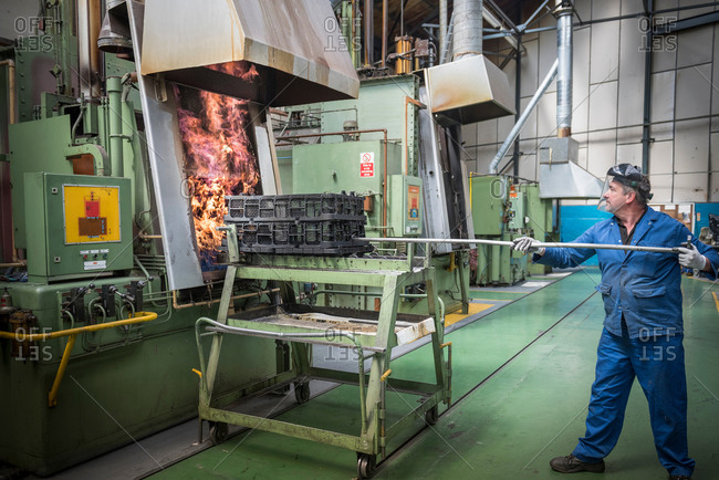 Engineer heat treating gear wheels in factory