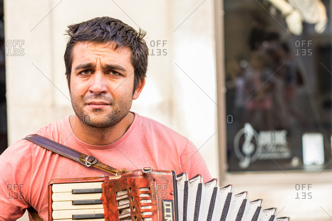 Lisbon, Portugal - October 23, 2014: Busker playing an accordion at the Praca do Comercio in Lisbon, Portugal