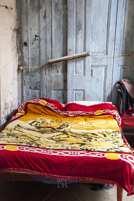 Bed in the interior of an old dilapidated building