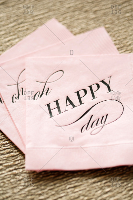 Pink cocktail napkin imprinted with the message 'Oh Happy Day'