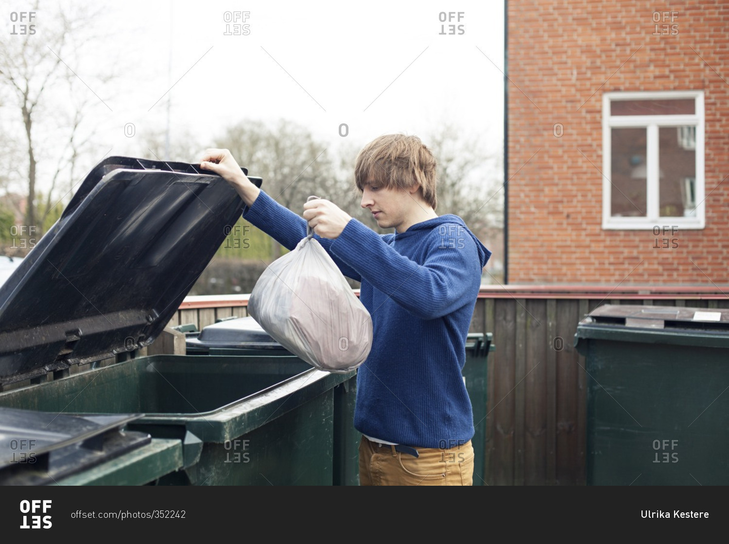 Young Man Throwing Garbage In Trash Bin On White Back vrogue.co