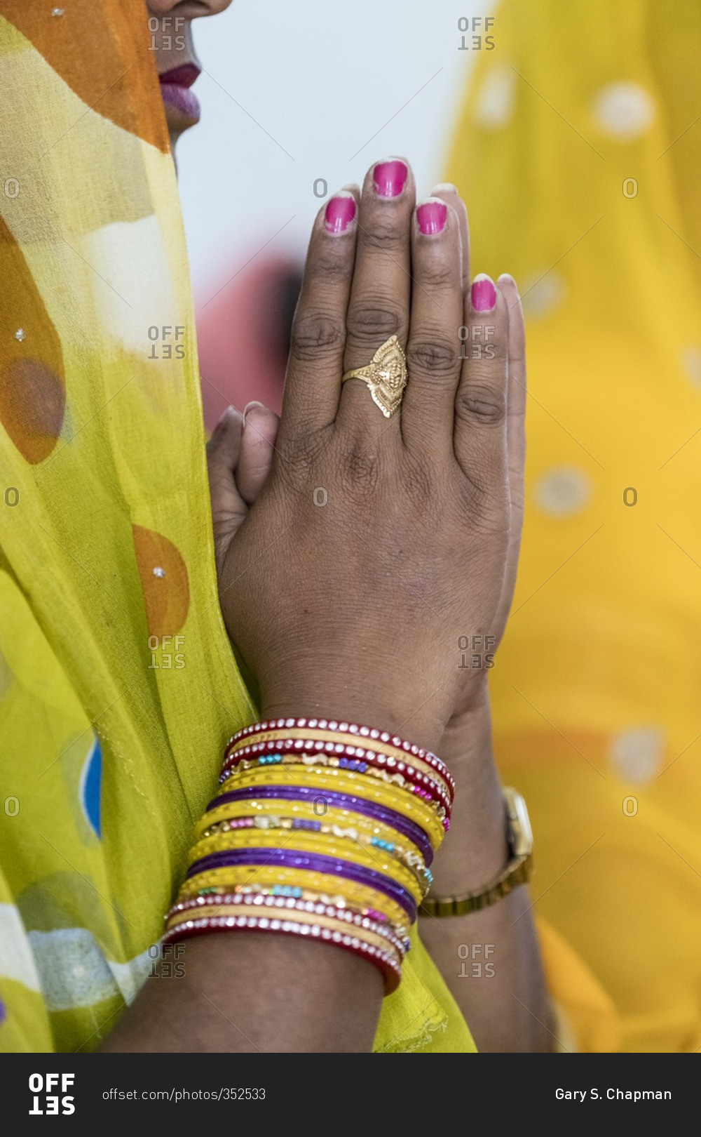 Hands of a praying woman at a Christian service in India