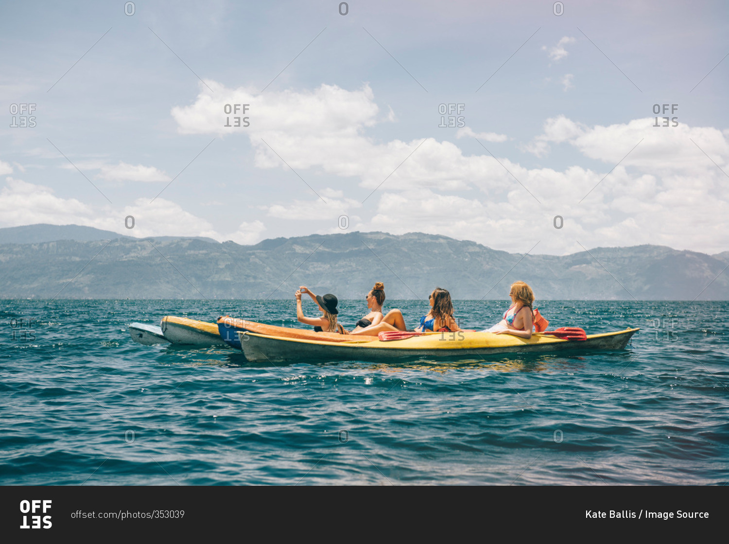 Four young female friends kayaking on Lake Atitlan, Guatemala