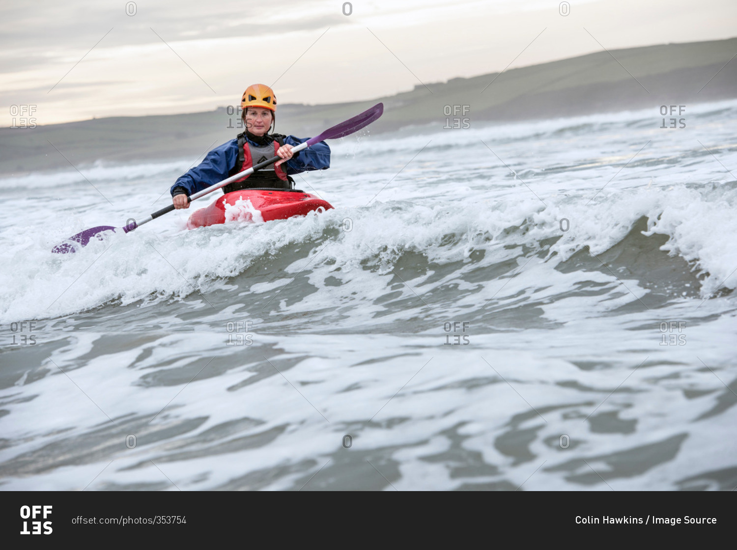 Mid adult woman sea kayaking
