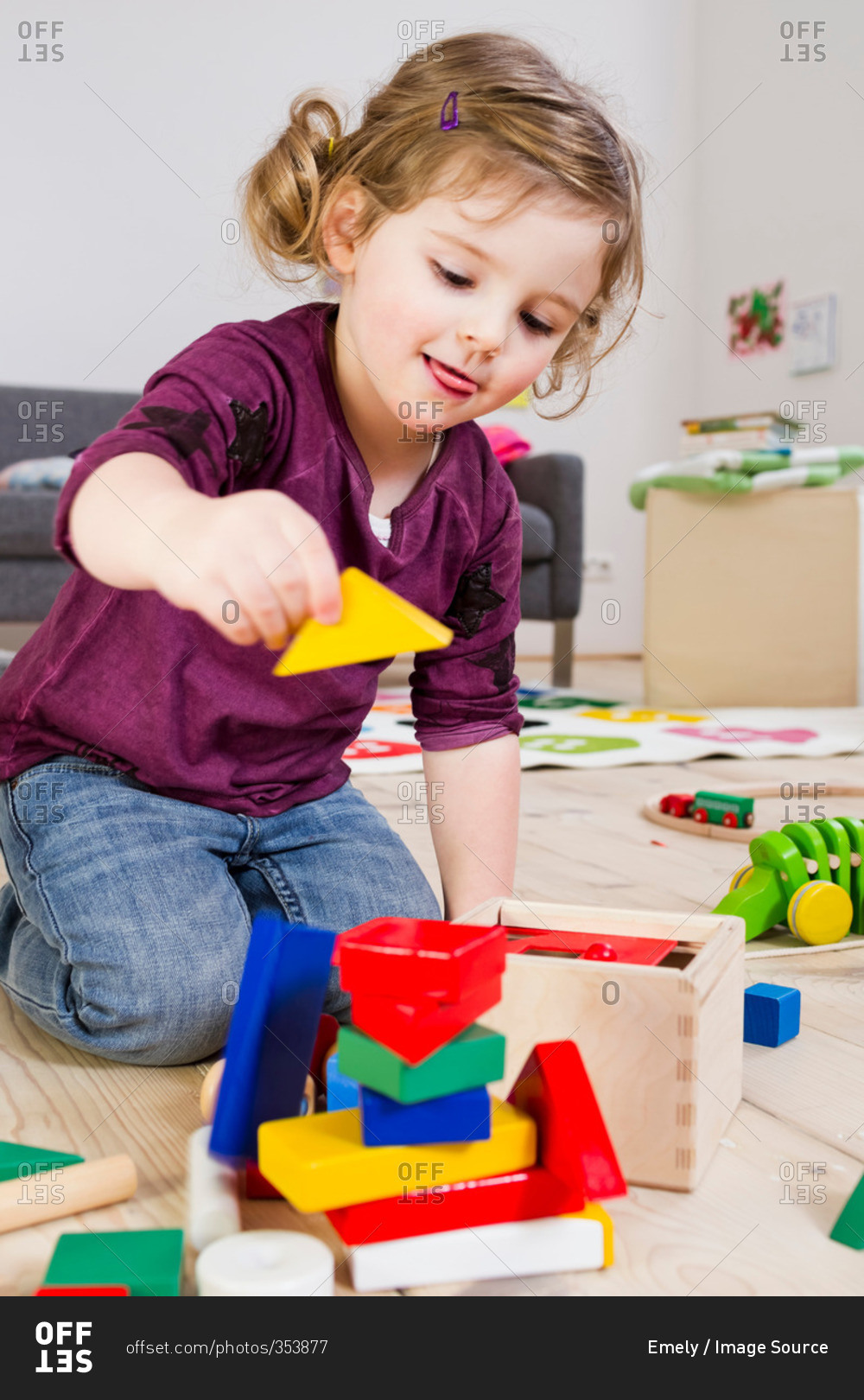 Girl playing with building blocks at home