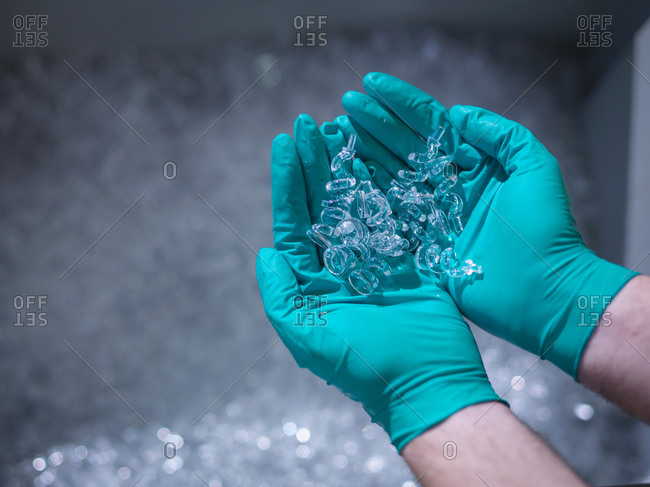 Worker holding finished moulded plastic in plastics factory, close up