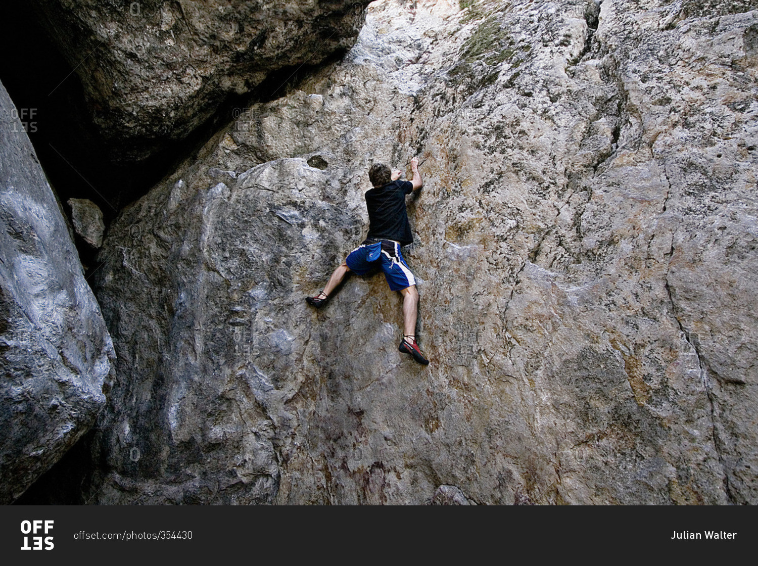 Man climbing a sheer rock face