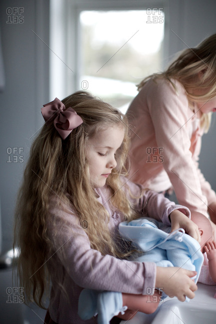 little girls playing with baby dolls