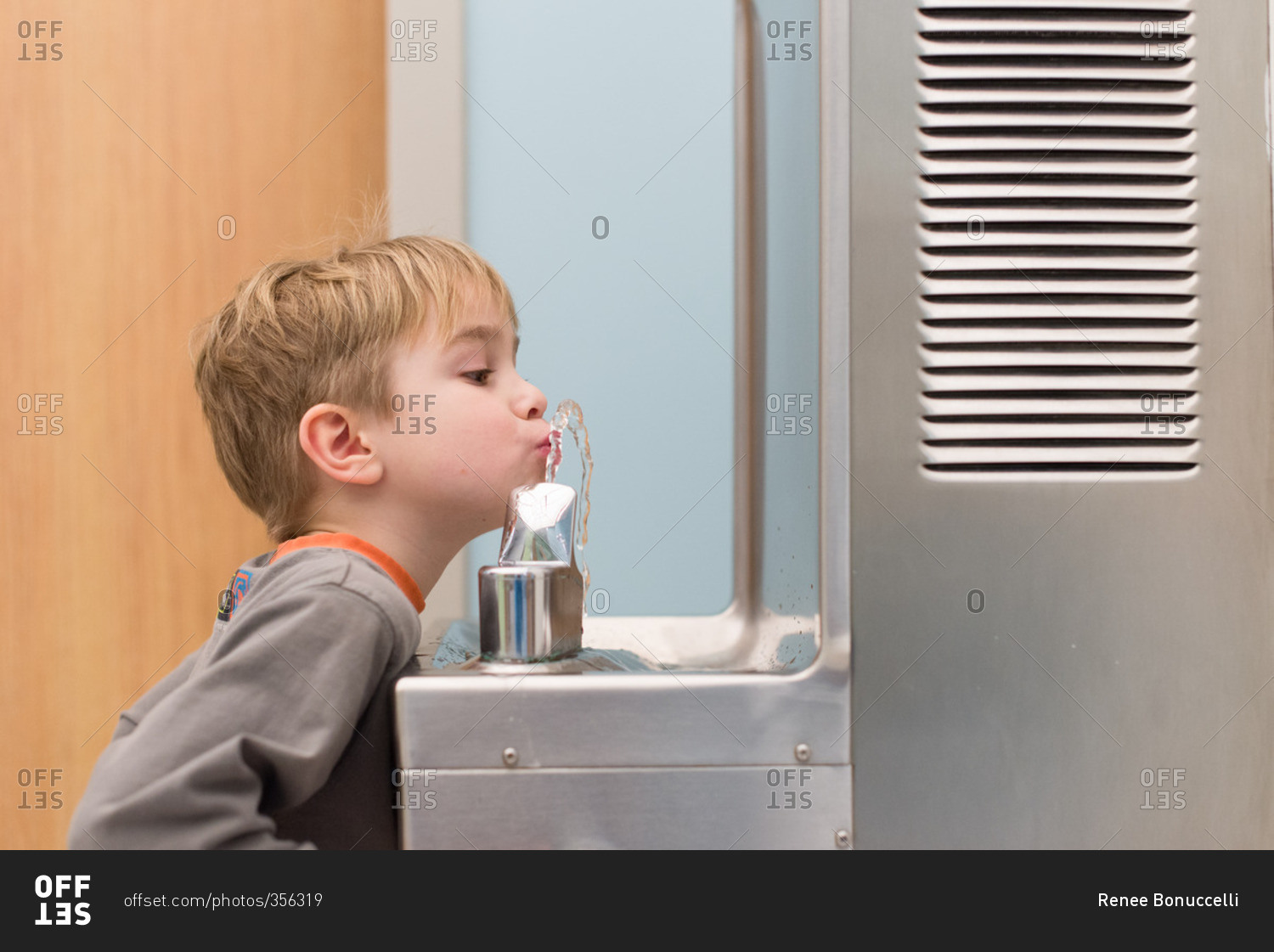 Boy at a water fountain