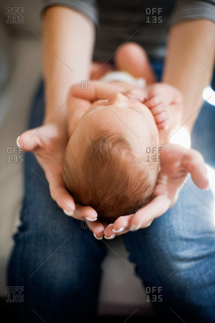 Baby laying in hands