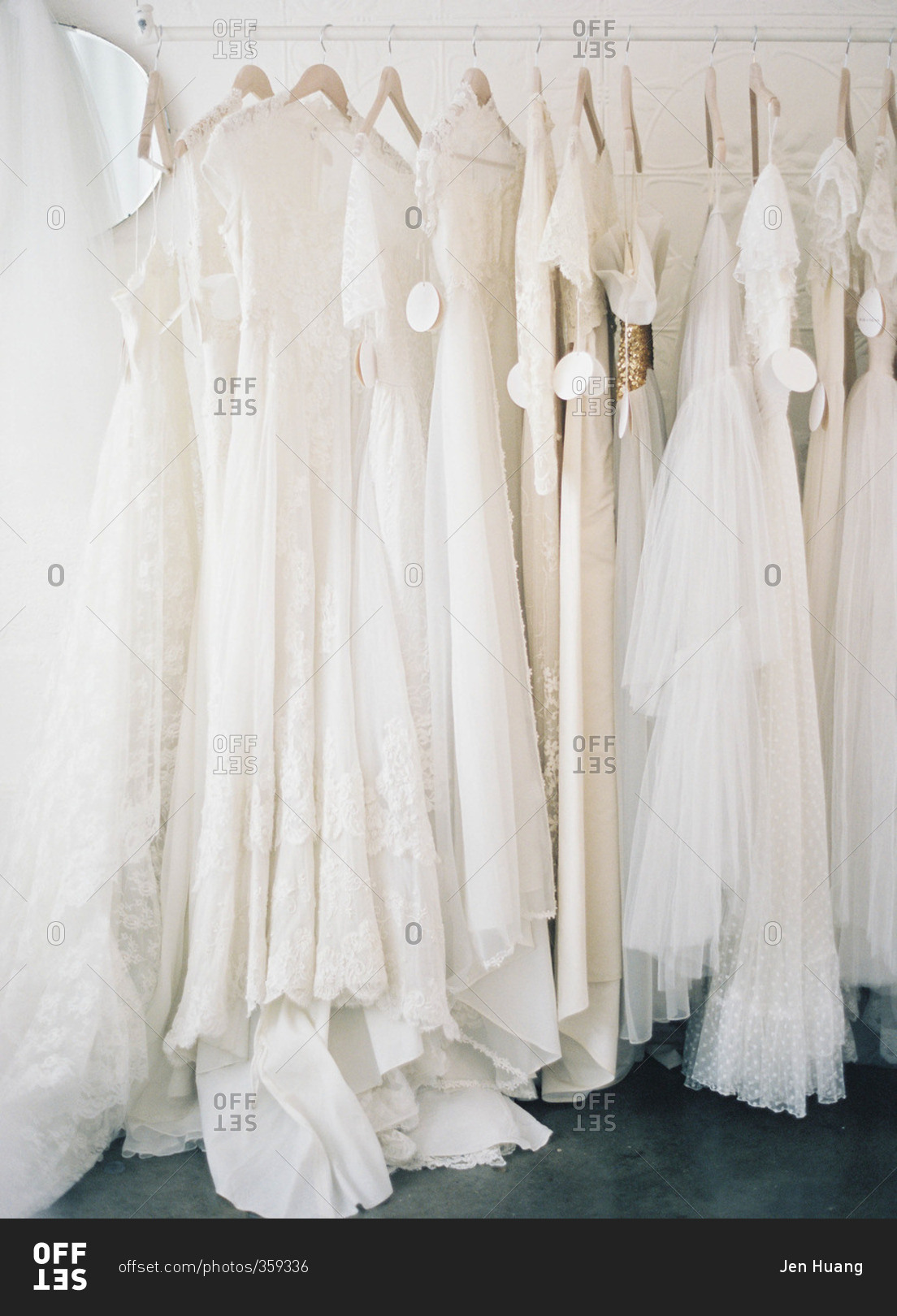 Variety of wedding gowns on a rack in a dress shop