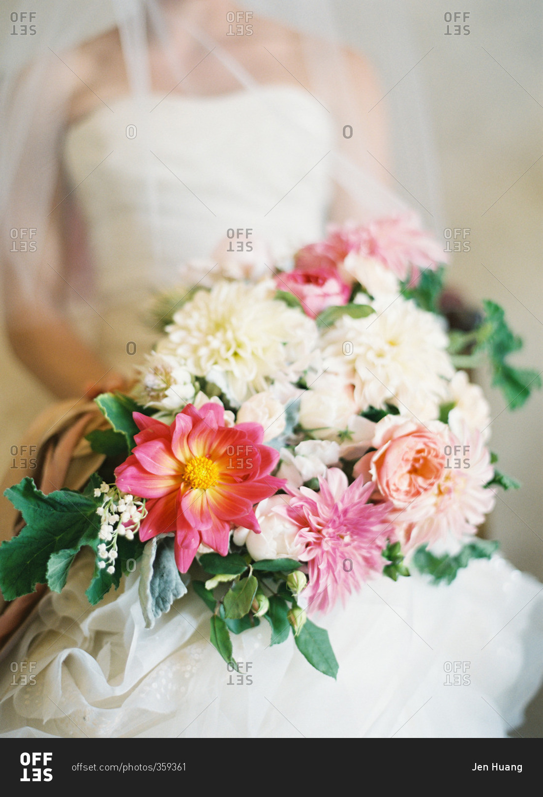 Bride holding bouquet with white and pink flowers
