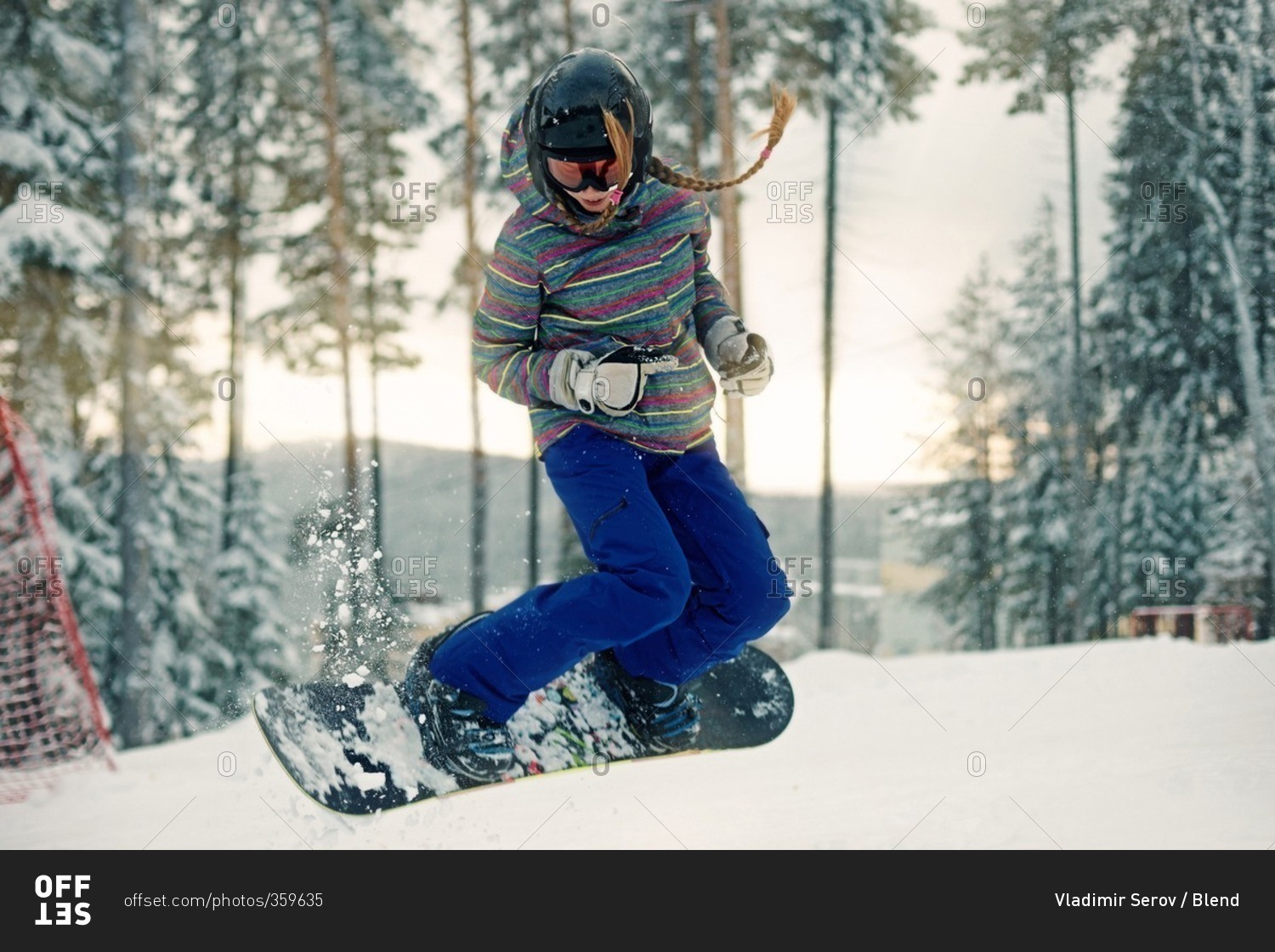 Caucasian girl riding snowboard in snow