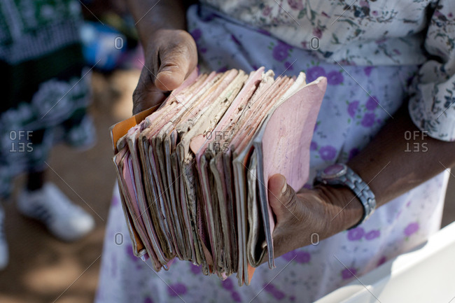 Close up of hands holding dilapidated treatment records