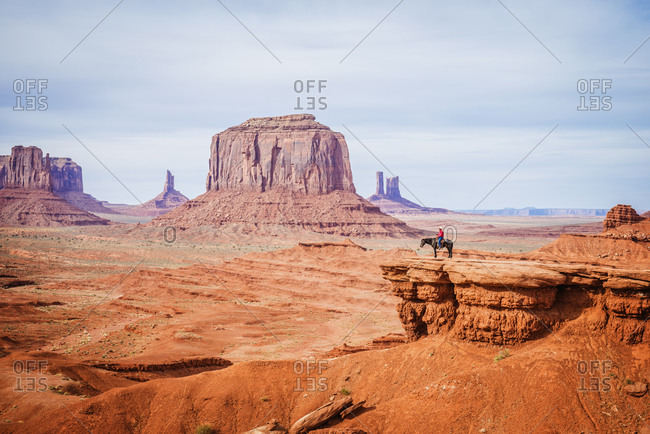 Horseback rider on rock formations in Monument Valley, Utah, United States