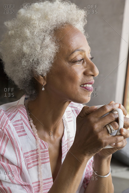African American woman drinking cup of coffee