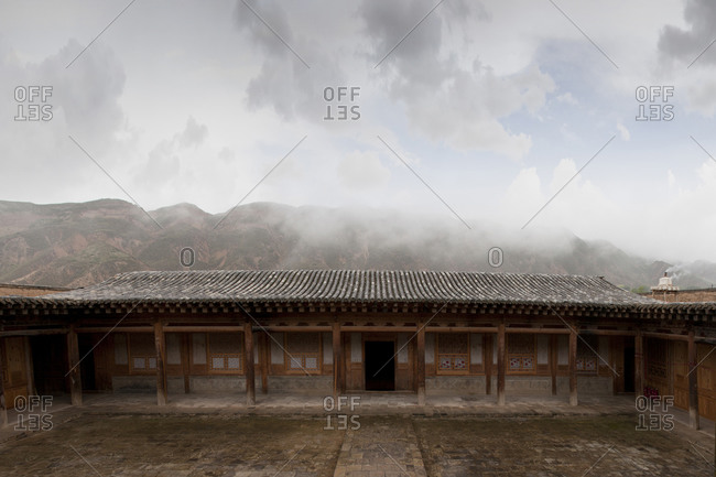 Remote monastery and cloudy sky, Qinghai, Tibet, China