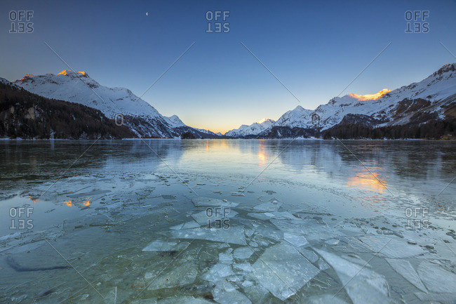 Sheets of ice on the surface of Lake Sils in a cold winter morning at dawn Engadine Canton of Graubunden Switzerland Europe