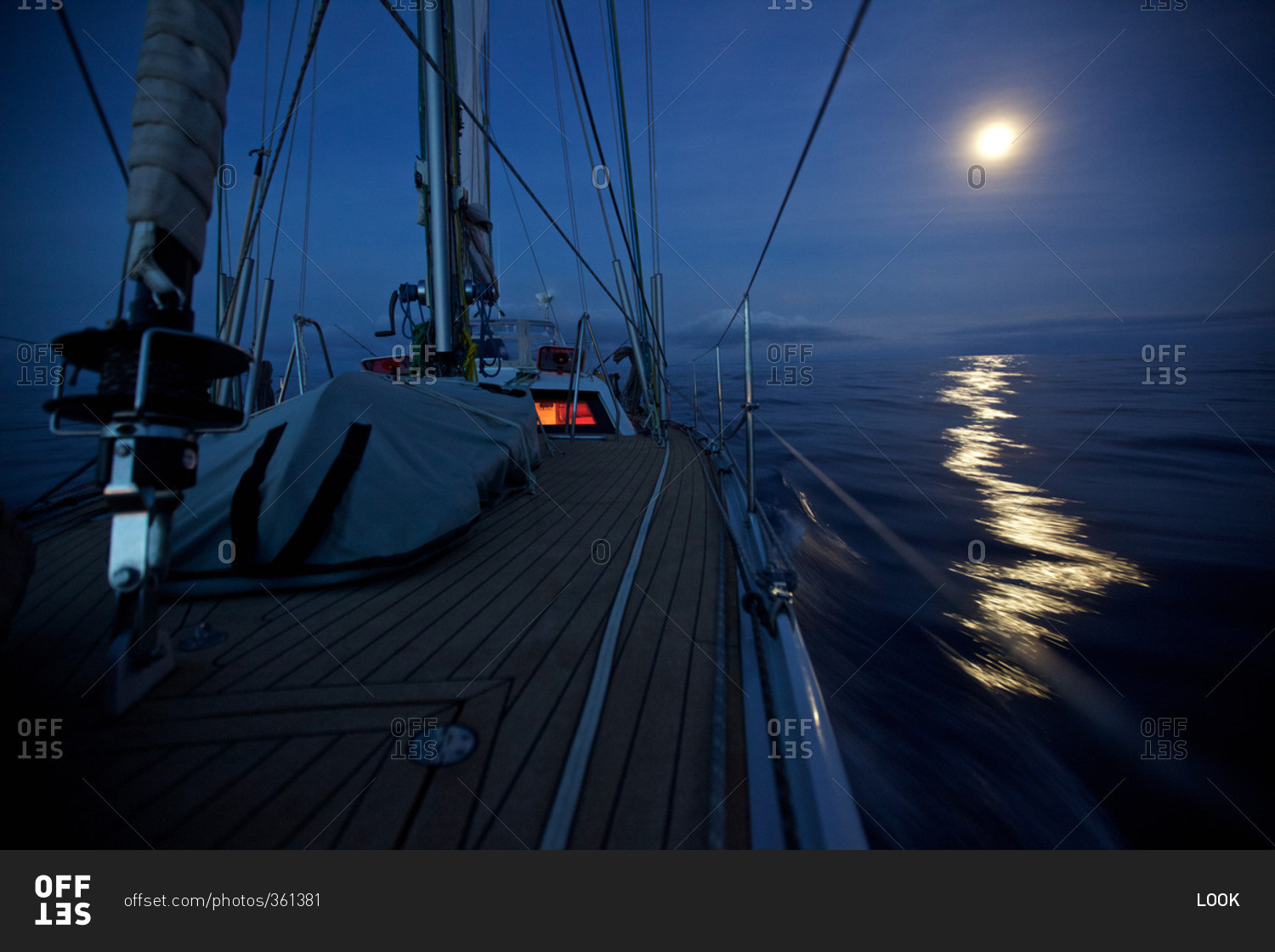 Sailing Boat Yacht With Night Lighting System And Full Moon During