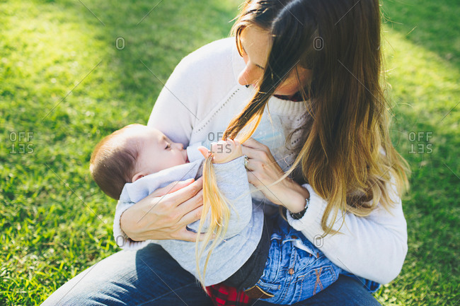 Breastfeeding Baby Pulling Mom S Hair Stock Photo Offset