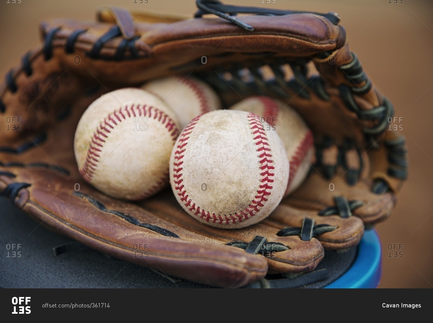 Close-up of baseballs in catchers mitt
