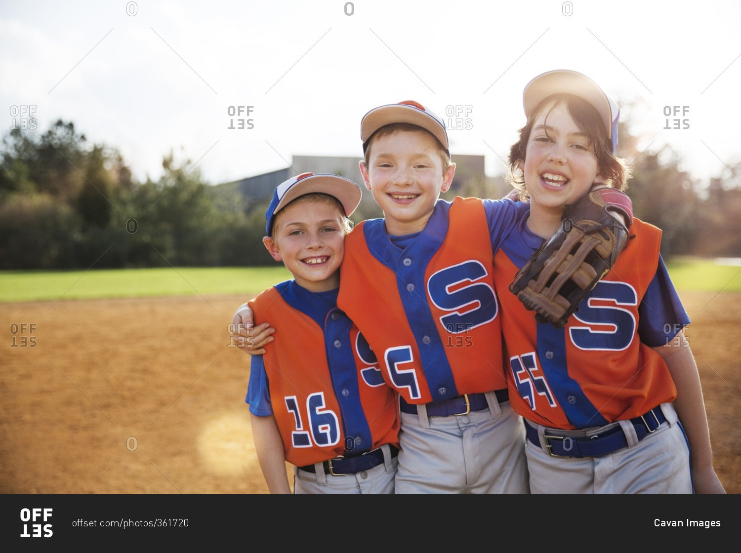 Portrait of happy baseball players standing on field