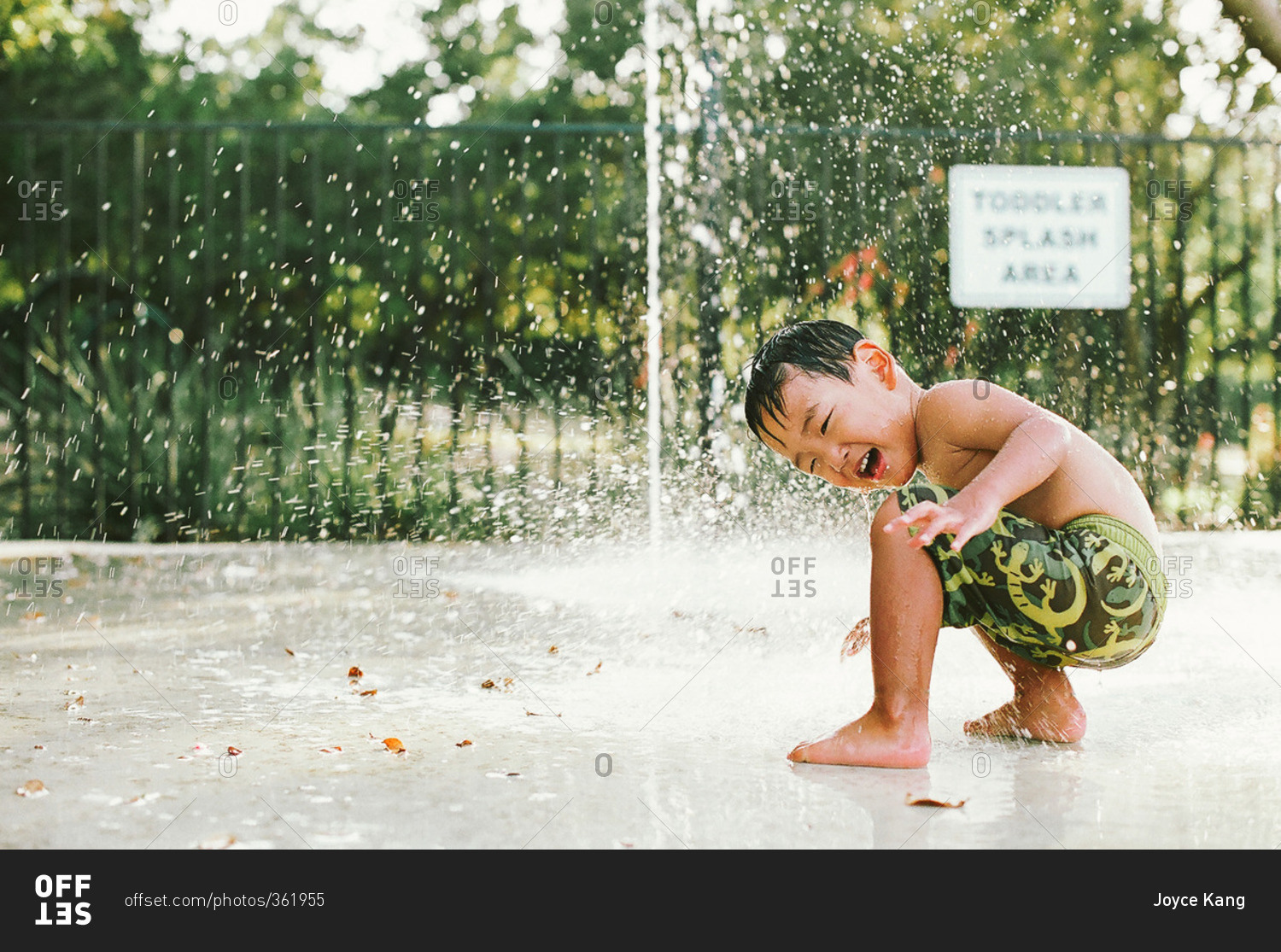 Boy playing in a fountain