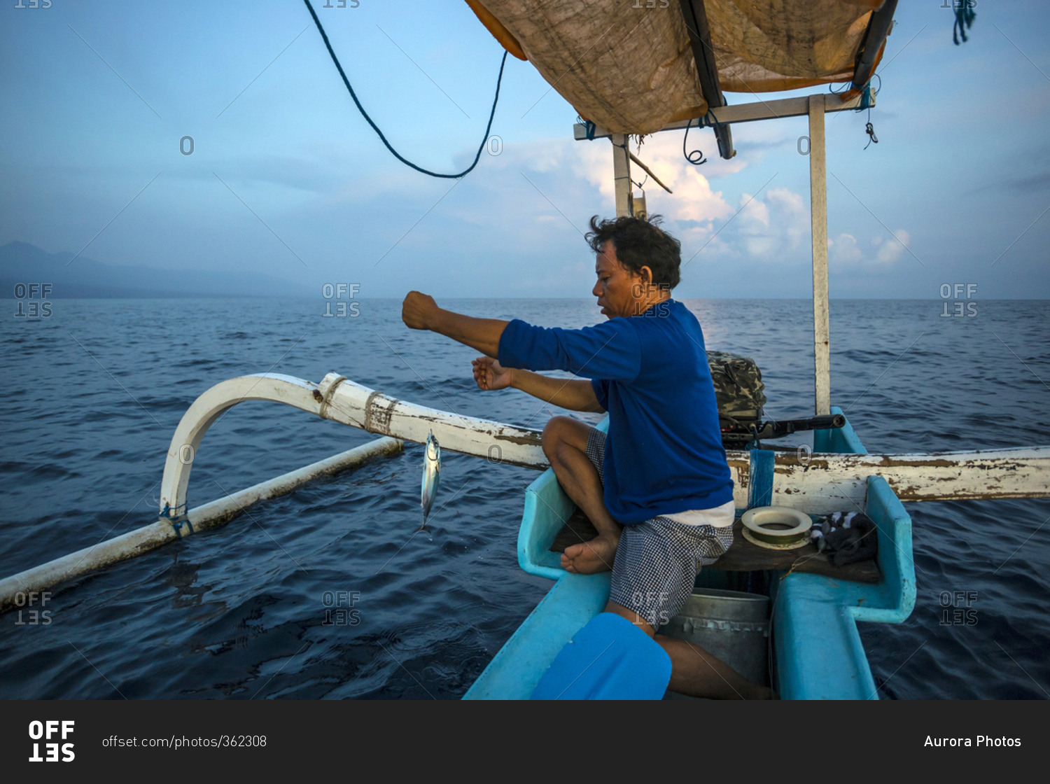 Balinese traditional fisherman with a fish on his line