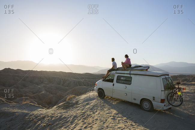 Borrego Springs, California, USA - January 1, 2000: Two people sitting atop their camper in the Badlands